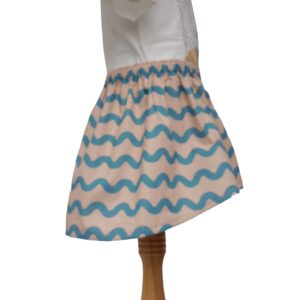 Mia Organic Cotton Skirt is an elasticized waist skirt with light pink and blue wavy lines. the front is shorter that the back of the skirt.
