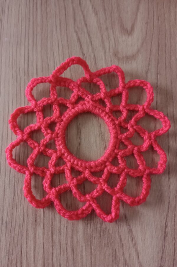 Tina scrunchie orange lace is made with bright orange yarn crocheted around hair tie.