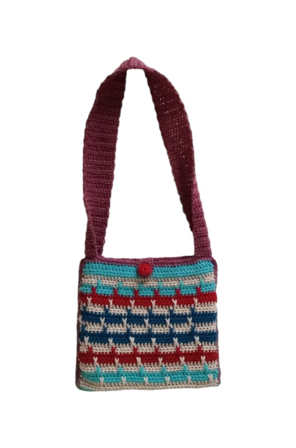 the front of April crochet bag features horizontal lines in blue, beige, red and aqua. A handmade red button is used for a closure.