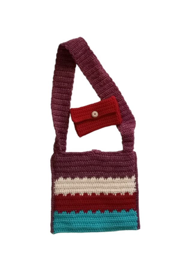 April Crochet Bag has the backside featuring horizontal stripes in aqua, reds and cream. Small, crocheted purse is made in cherry red.