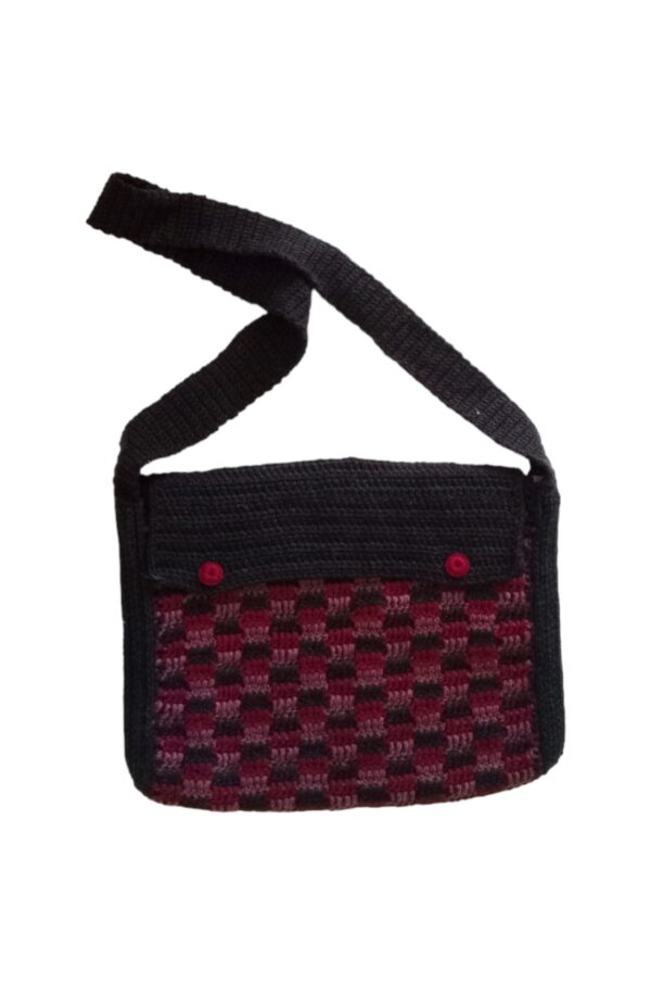 Satchel style bag is a rectangle shaped bag using reds and charcoal tones.