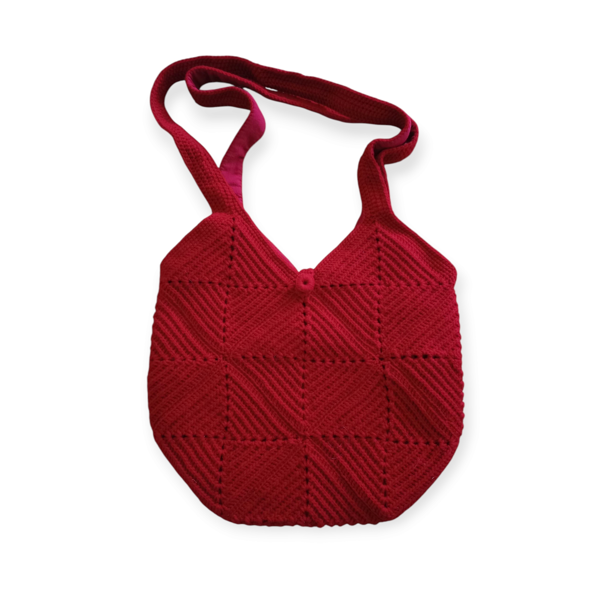Cherry Crochet Bag shown in flatlay, featuring red square crochet patches with diagonal texture, matching strap, and button closure.