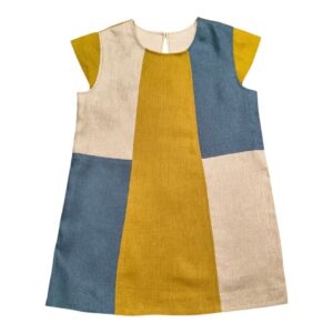 Front view of handmade linen dress with cap sleeves and bold colorblock panels in mustard yellow, gray blue and off white