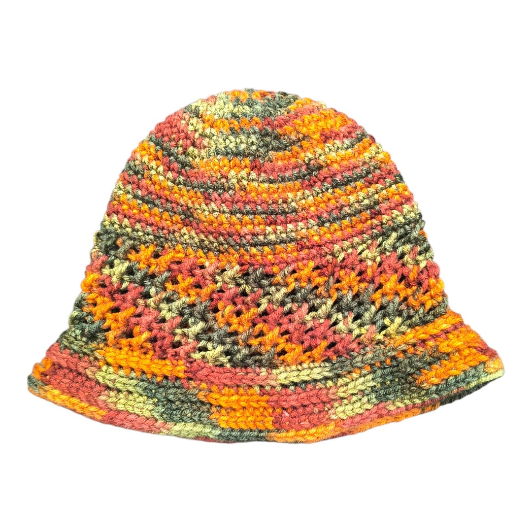 Hand‑crocheted girls’ hat in autumn tones with mixed tight and lace stitches and a ribbed brim, sized for ages 4–8.