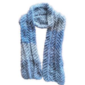 Handmade knitted lace scarf in a sky-blue ombre gradient with a soft, wavy texture.
